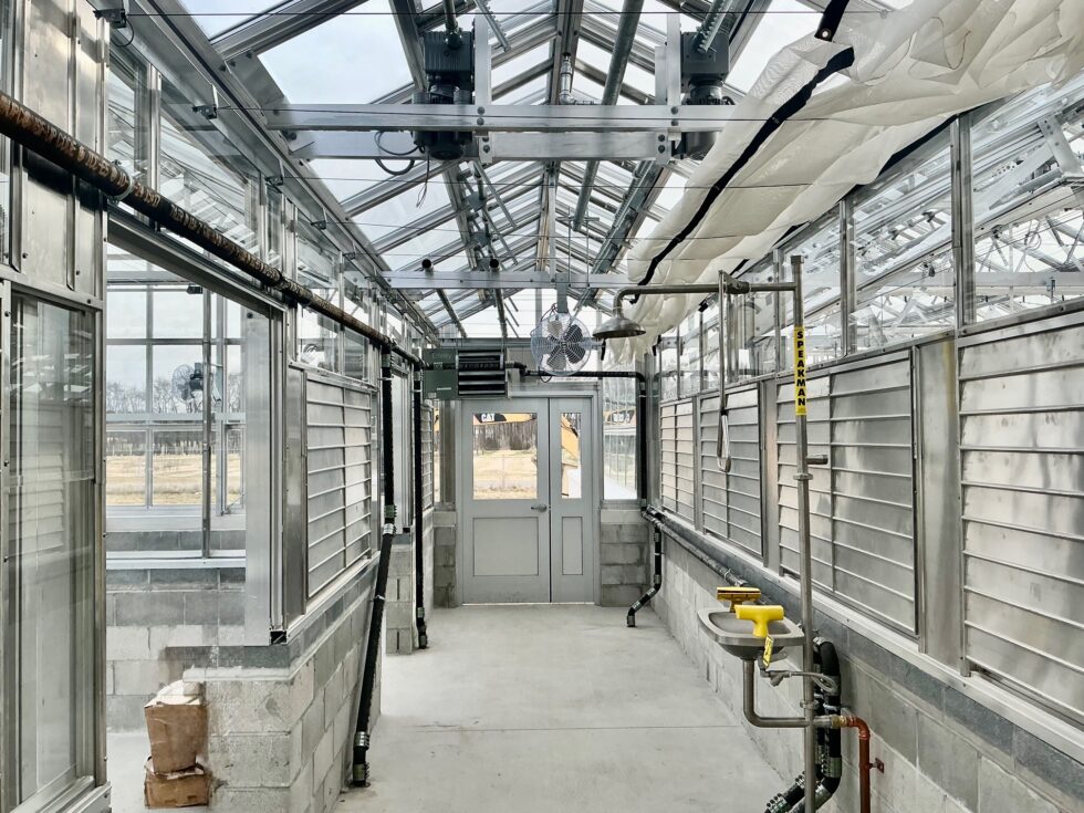 Interior commercial greenhouse installation by LLK Greenhouse Solutions