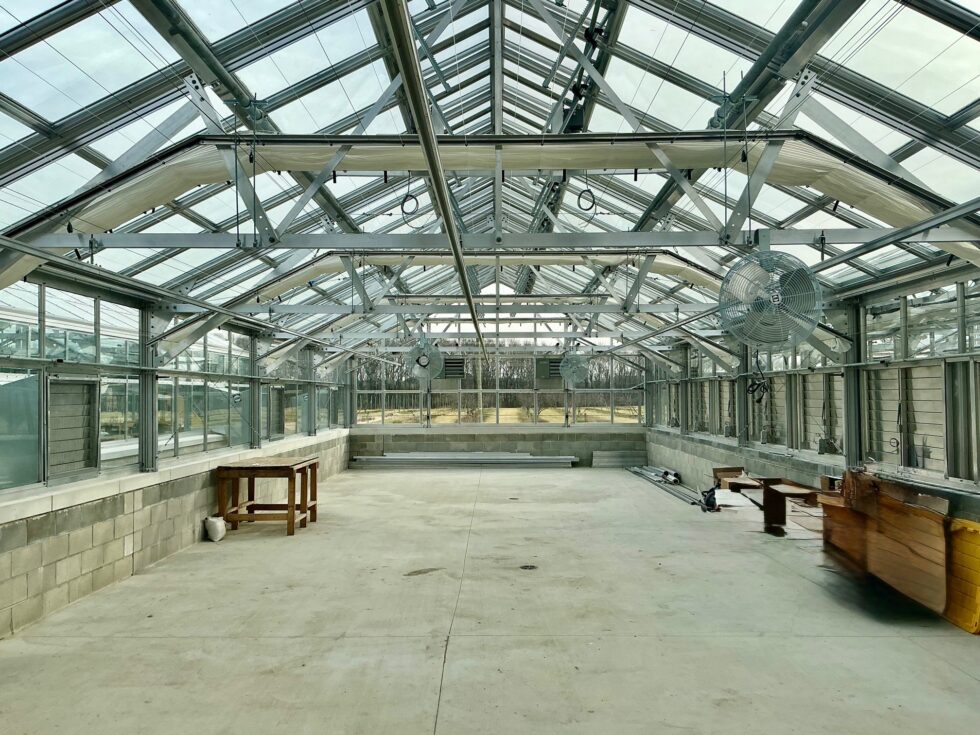 Interior commercial greenhouse installation by LLK Greenhouse Solutions