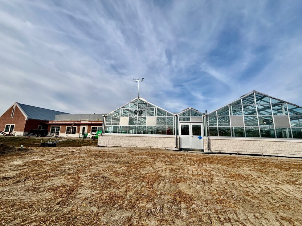 Exterior commercial greenhouse installation by LLK Greenhouse Solutions