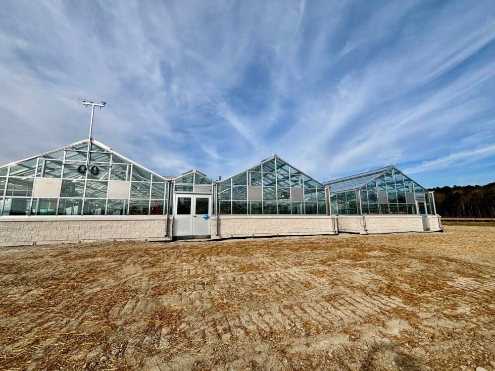 Exterior commercial greenhouse installation by LLK Greenhouse Solutions
